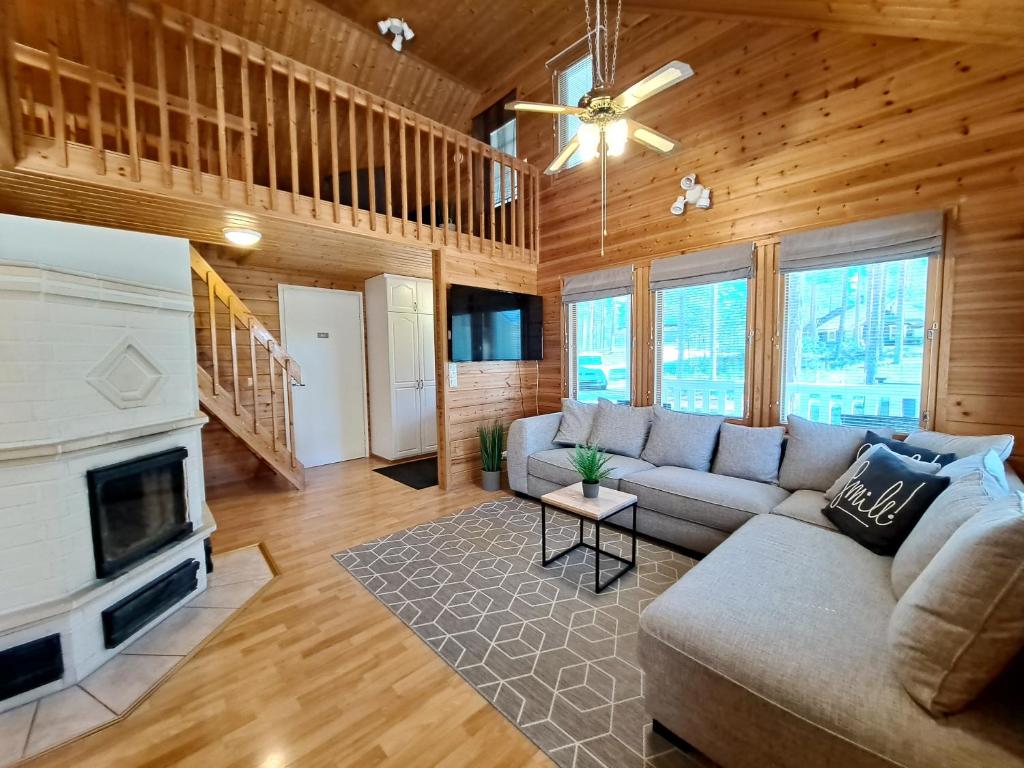 a living room with a couch and a fireplace at Jukuvilla in Kalajoki