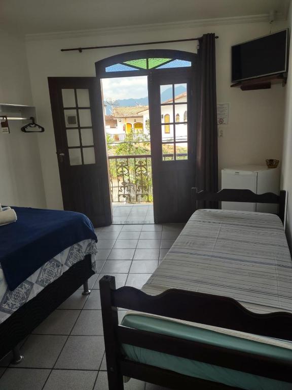 Postel nebo postele na pokoji v ubytování Pousada Caravelas - Centro de Paraty