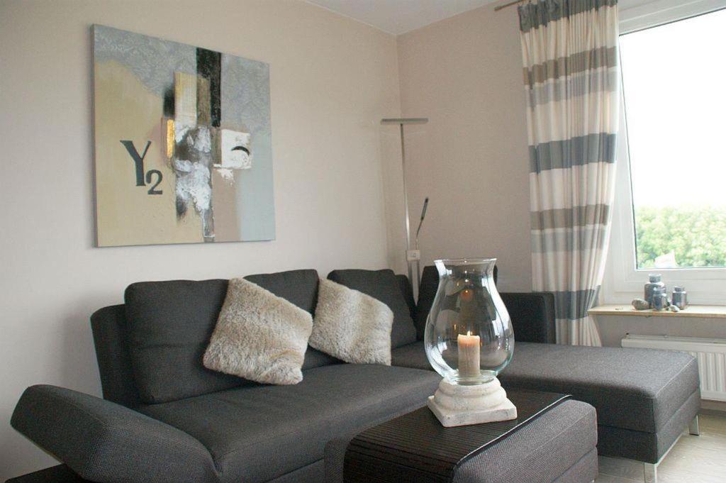 a living room with a couch and a table at Ferienwohnung Pape in Glücksburg
