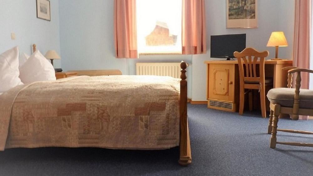 Postel nebo postele na pokoji v ubytování Hotel garni Floriani