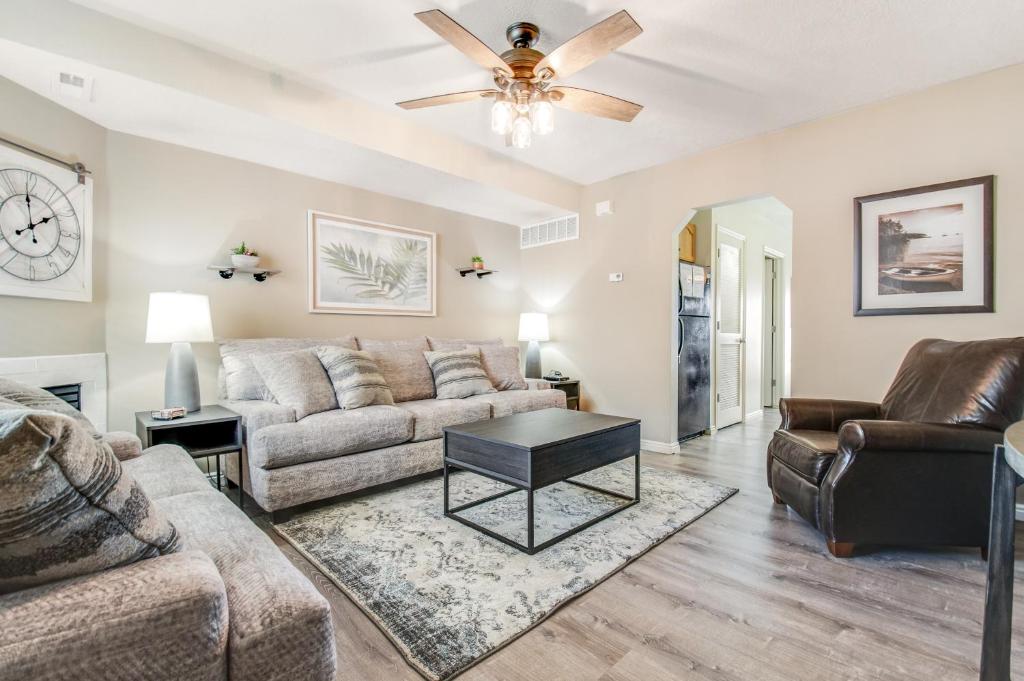 a living room with a couch and a ceiling fan at Bear Lake Blue in Garden City