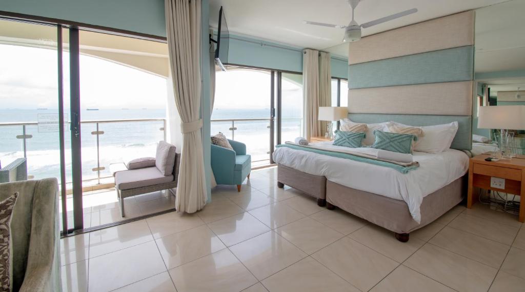 a bedroom with a bed and a view of the ocean at 803 Bermudas - by Stay in Umhlanga in Durban