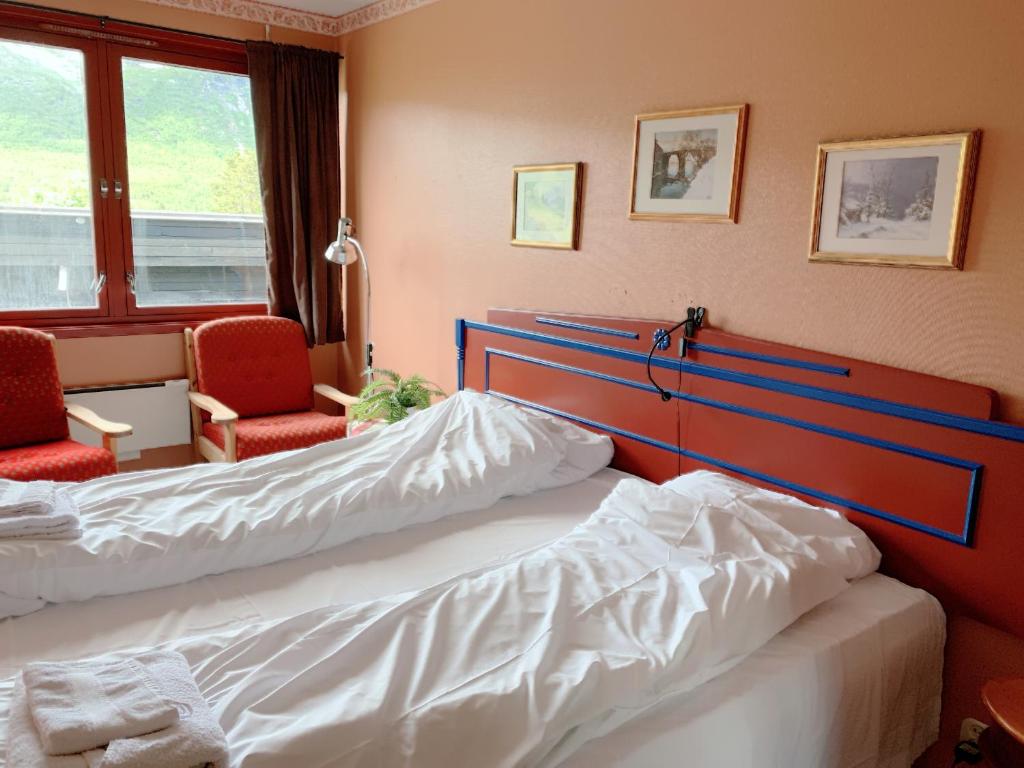pokój hotelowy z 2 łóżkami i 2 krzesłami w obiekcie Hallingskarvet Fjellstue as w mieście Hovet