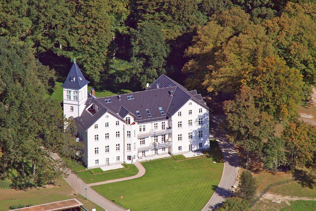 an aerial view of a large white building with a black roof at Traumurlaub im Schloss Hohen Niendorf in Bastorf