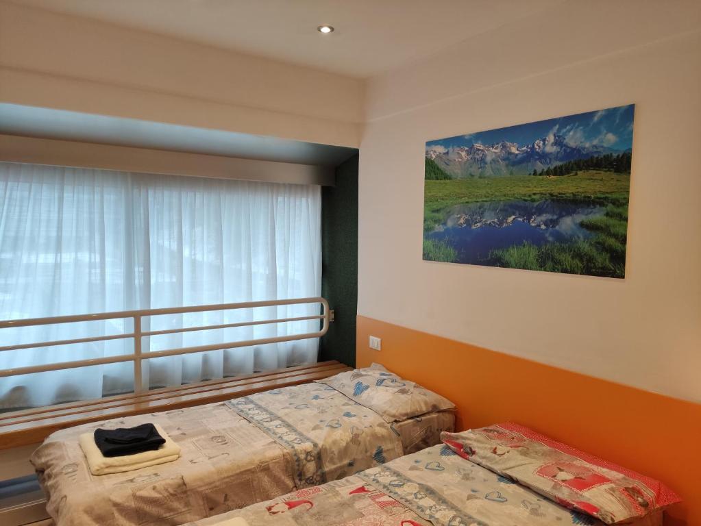 Postel nebo postele na pokoji v ubytování Doss della Pesa Apartment