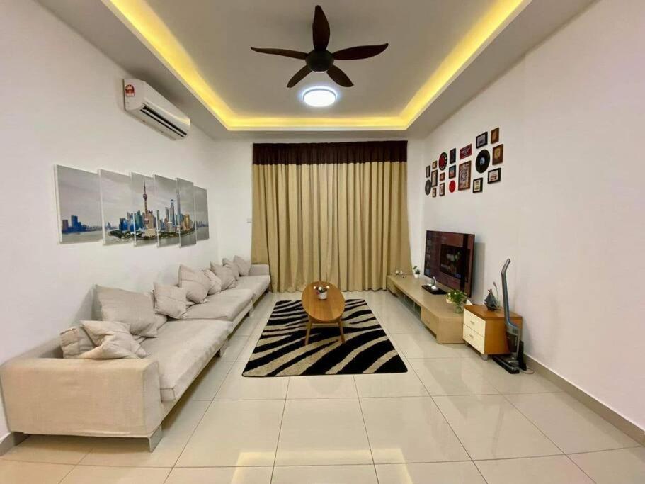 a living room with a couch and a ceiling fan at SWEET HOME SKY GARDEN@BM in Bukit Mertajam