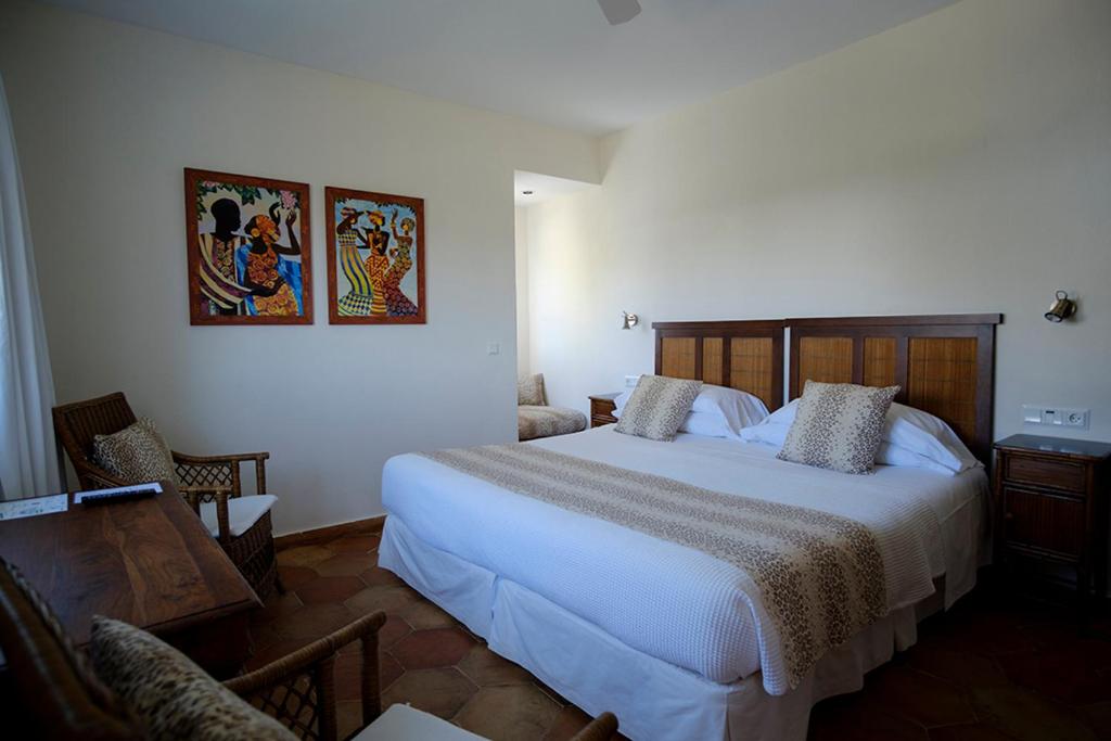 a bedroom with a large white bed in a room at miKasa Agua Amarga & SPA in Agua Amarga