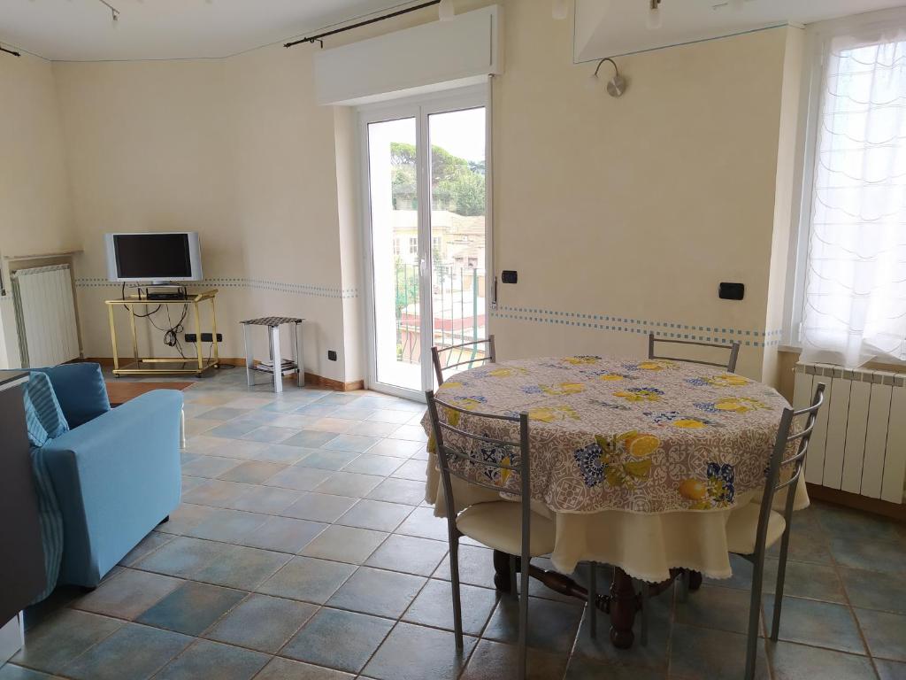 a dining room with a table and a tv at Castelletto al mare in Rapallo