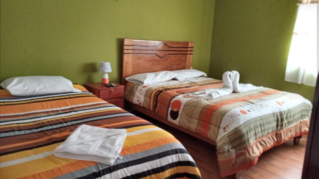 Postel nebo postele na pokoji v ubytování Casa Salkantay Cusco