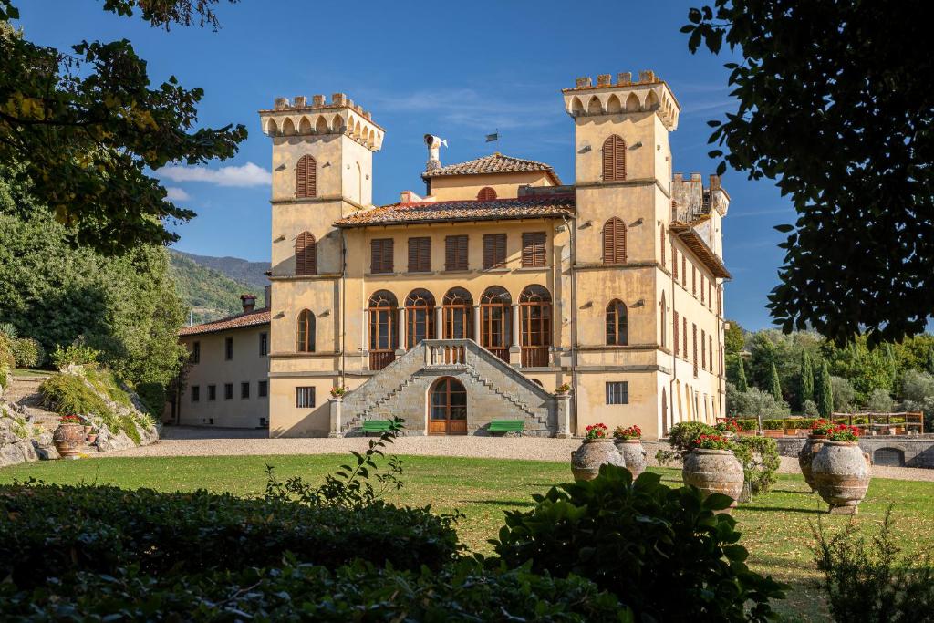 a large building with a tower on top of it at Agriturismo I Bonsi in Reggello