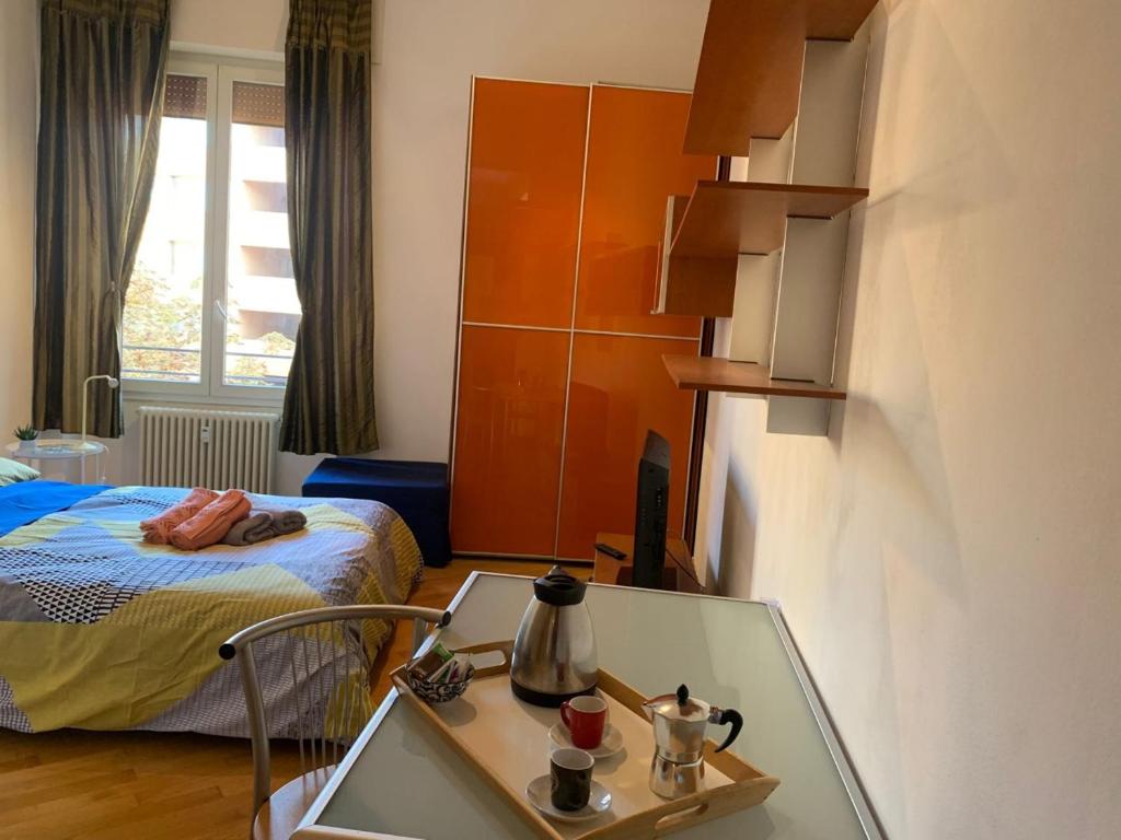 a hotel room with a table and a bed at Central flat beetwen centre and railway station!! in Bologna