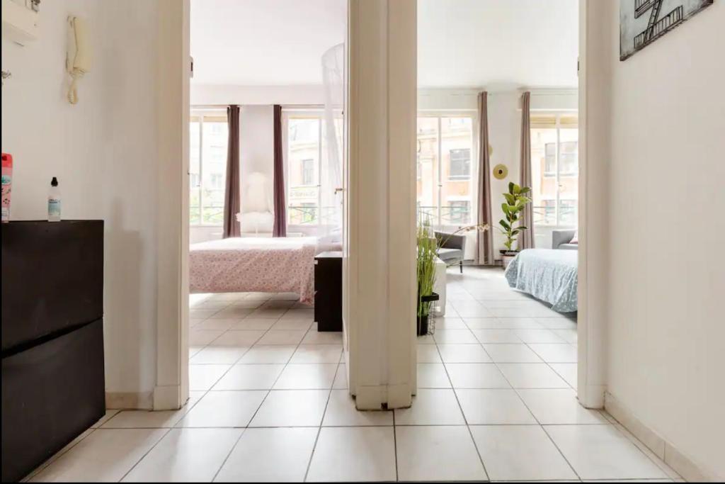 a white hallway with a bedroom and a bed at Apt Chic, 60m2, 2 Chambres, Centre in Valenciennes