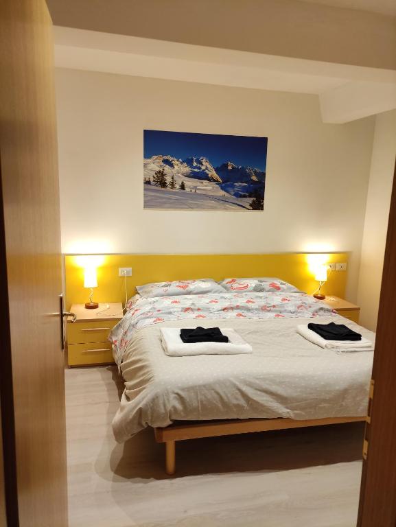 Postel nebo postele na pokoji v ubytování Doss della Pesa Apartment