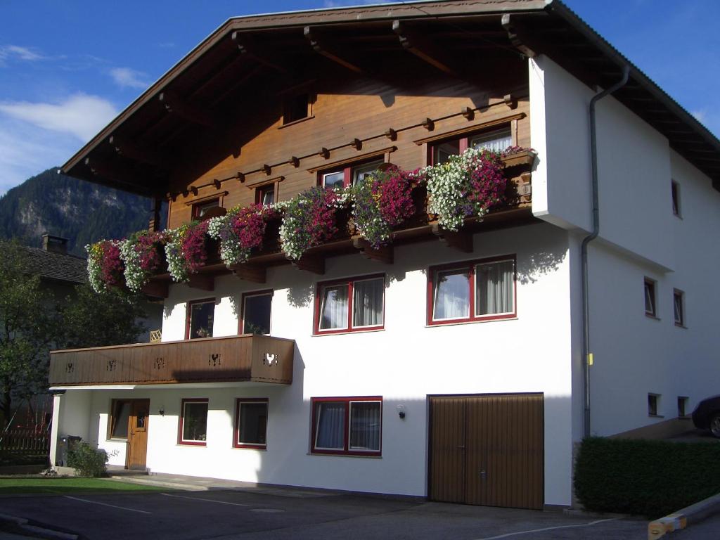 a building with flower boxes on the side of it at Gästehaus Geisler in Hippach