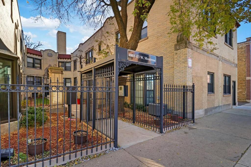 a black gate in front of a building at Appealing 1BR Apartment in Portage Park - Montrose 2S in Chicago