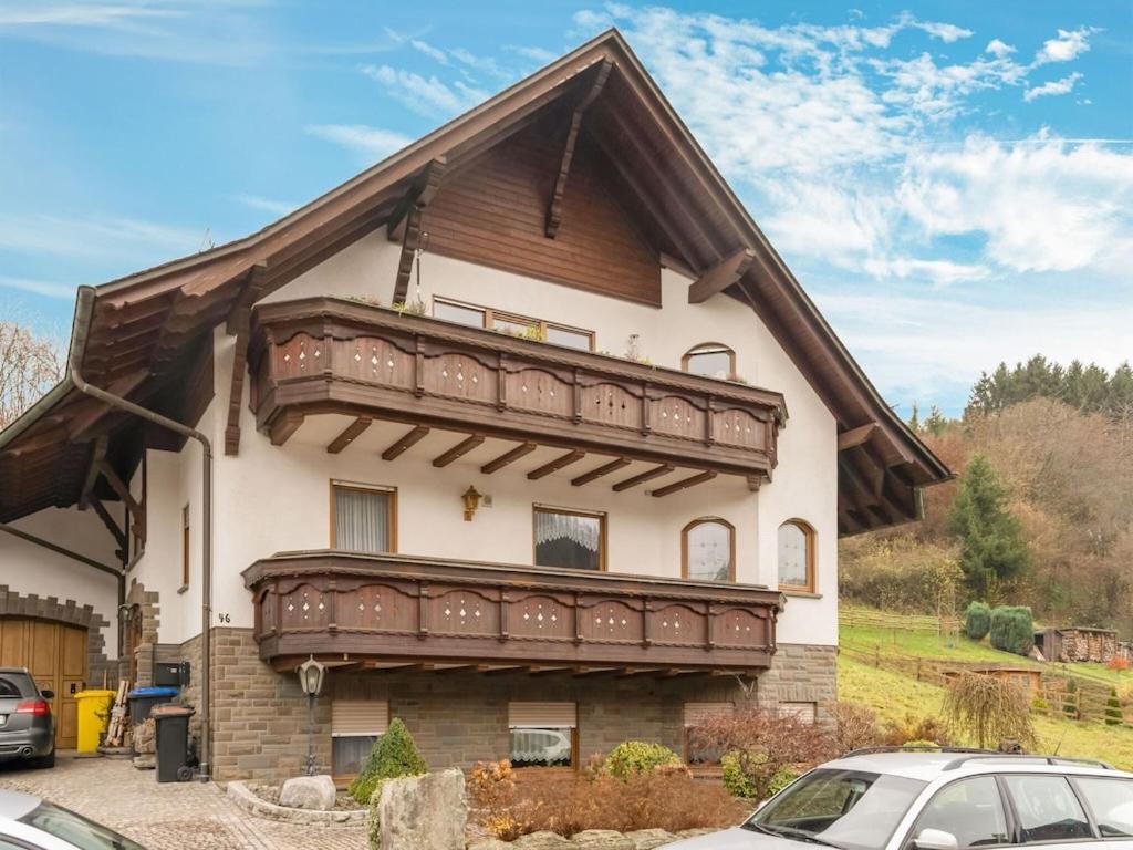 a house with a large balcony on top of it at Spacious flat in Adenau near the N rburgring in Adenau