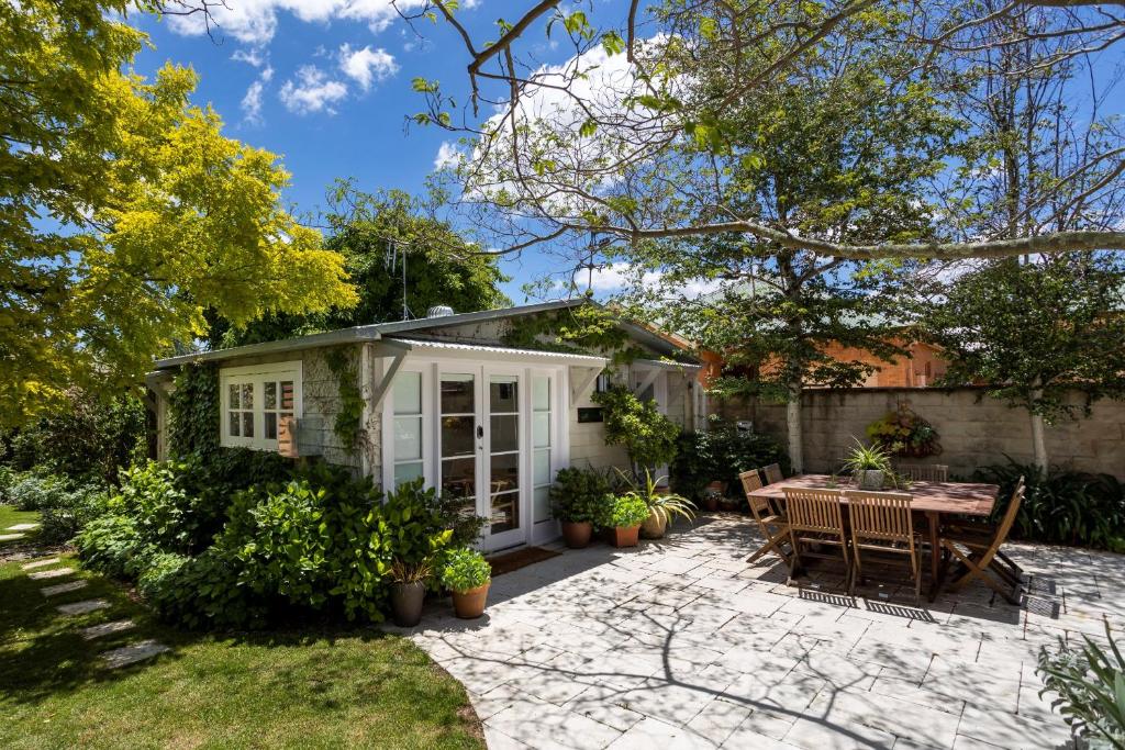 a house with a patio and a table and chairs at Silk Tree Studio - Steps to Cook Park in Orange