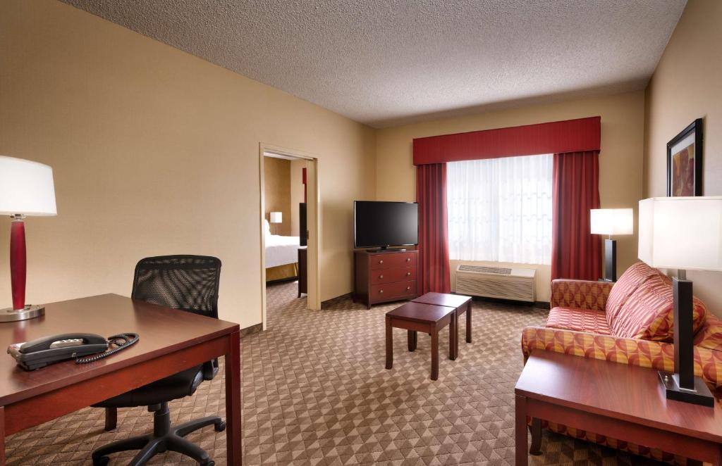 a hotel room with a desk and a living room at Best Western Downtown Phoenix in Phoenix