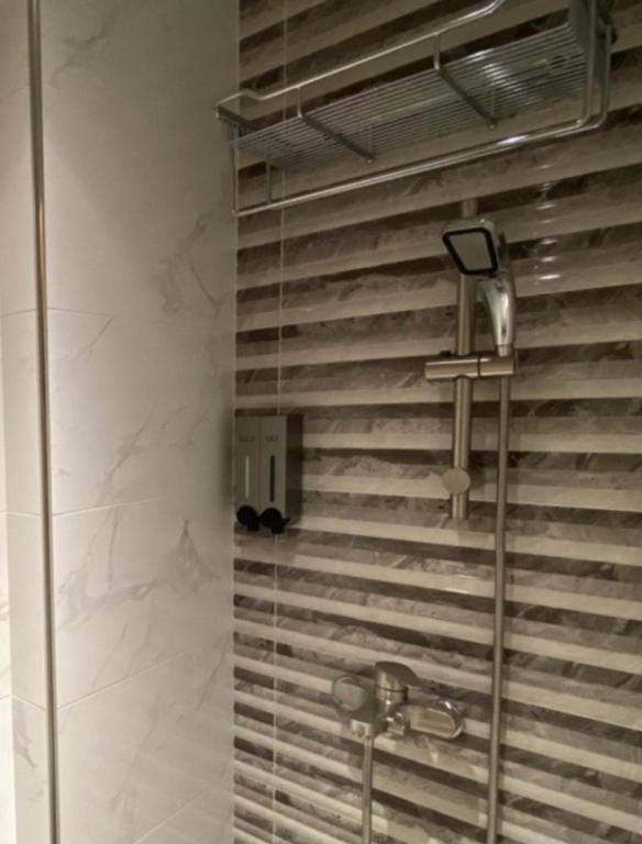 a bathroom with a shower with a glass door at Dot Minsu in Wujie