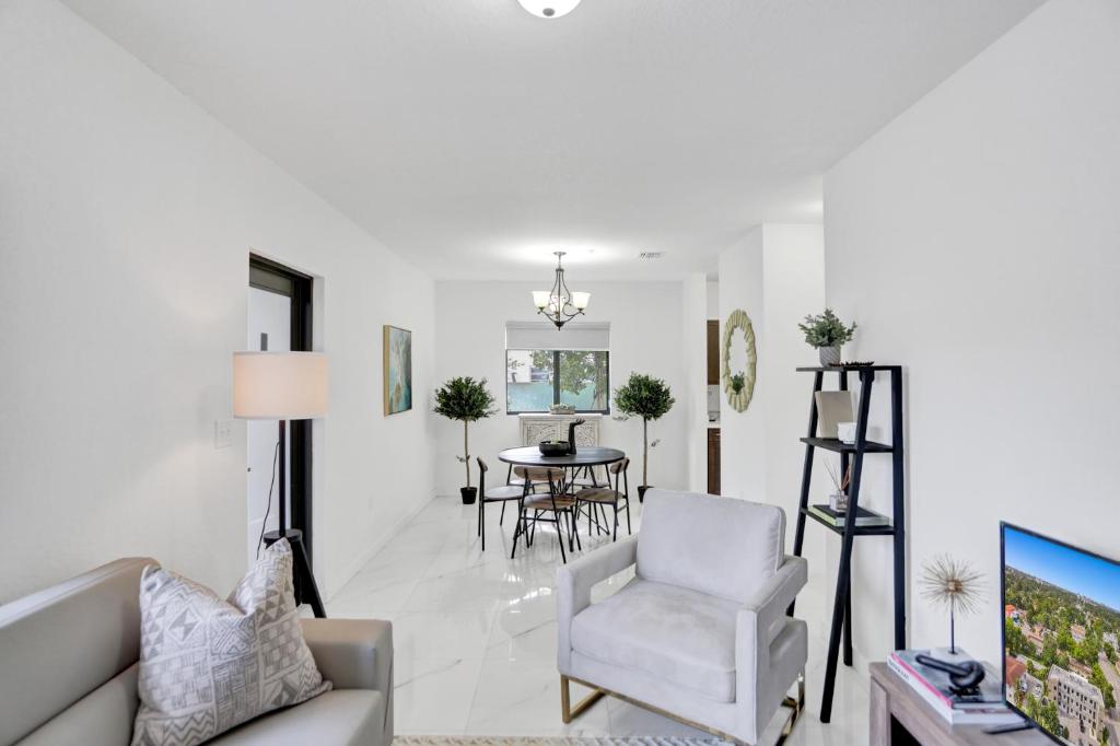 a living room with a couch and a chair and a table at Renzzi Wynwood Apartments in Miami