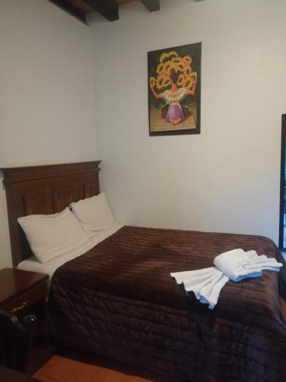 Postel nebo postele na pokoji v ubytování Hotel Colonial