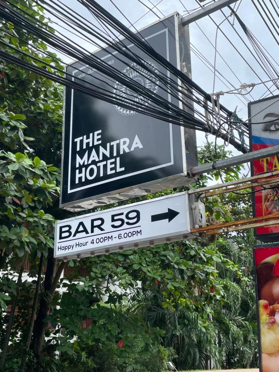 a sign for the marina hotel with an arrow on it at The Mantra Hotel Kata Noi in Kata Beach