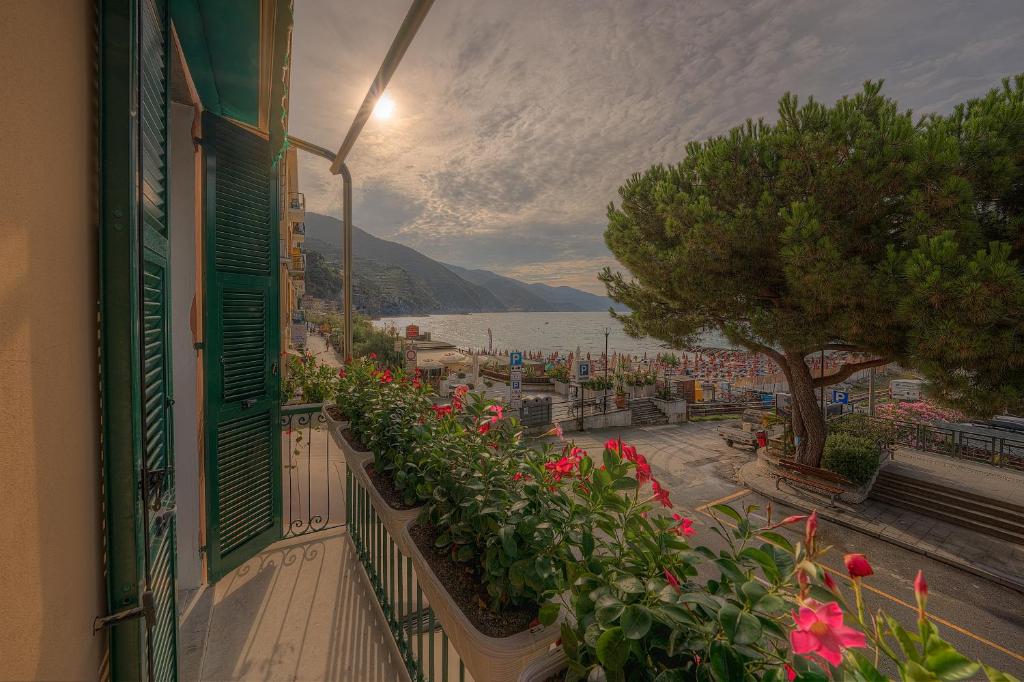 a balcony with flowers and a view of the water at Affittacamere Da Flo in Monterosso al Mare