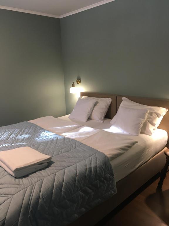 ein Schlafzimmer mit einem großen Bett mit weißer Bettwäsche und Kissen in der Unterkunft Decor Park Apartament in Karpacz
