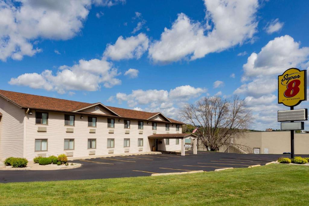 a large white building with a sign in front of it at Super 8 by Wyndham Decorah in Decorah