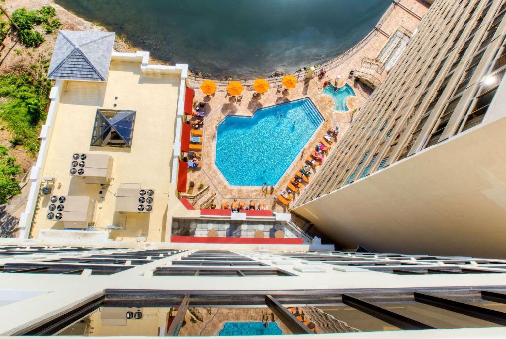 a view of the pool from the top of a building at Ramada Plaza by Wyndham Orlando Resort & Suites Intl Drive in Orlando