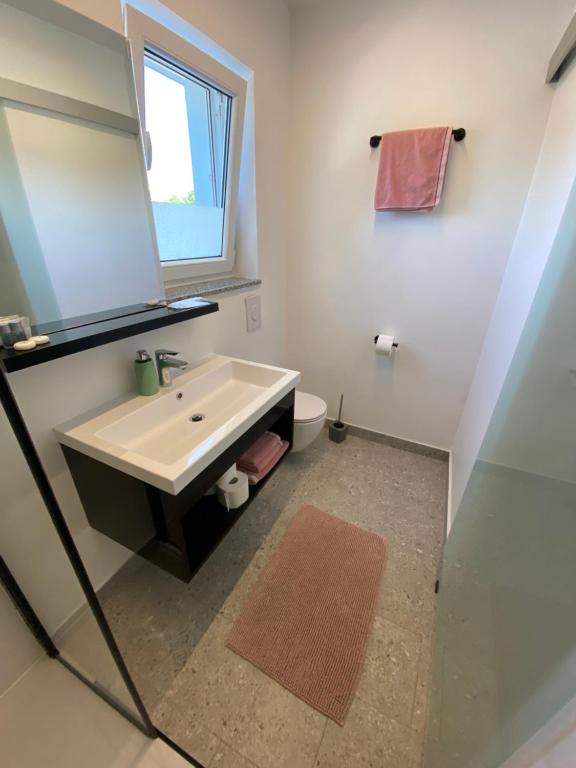 Kúpeľňa v ubytovaní Apartmani Kumenat