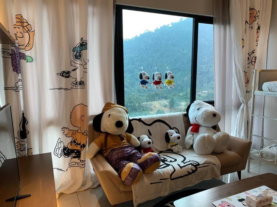 a group of stuffed teddy bears sitting on a couch at Genting Geo38 Residence Snoopy Studio in Genting Highlands