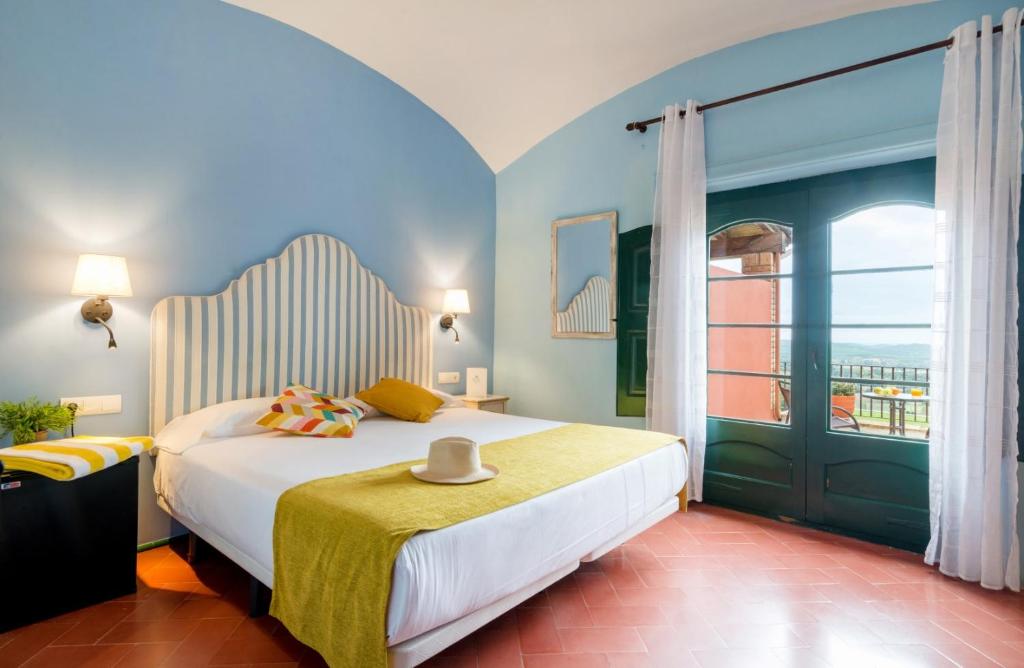 a bedroom with a large bed and a window at Mas Ses Vinyes - Adults Only in Begur