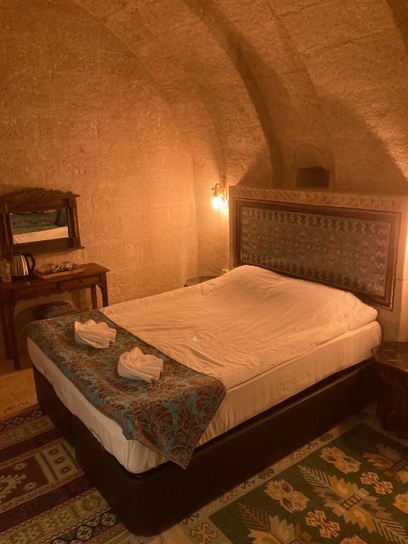 Postel nebo postele na pokoji v ubytování Monte Cappa Cave House