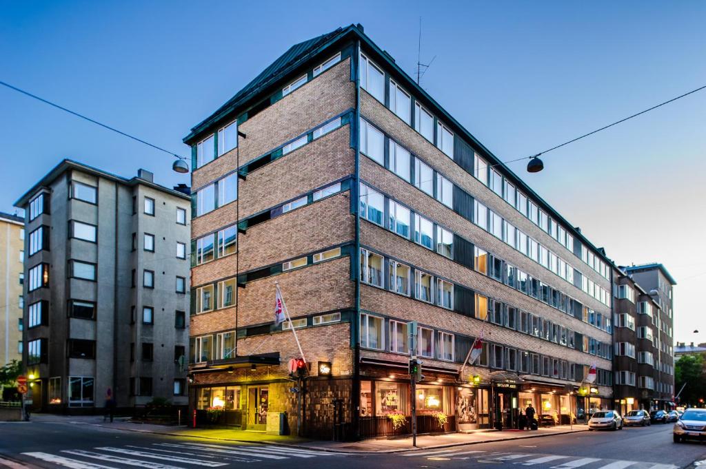 a tall brick building on a city street at Original Sokos Hotel Albert in Helsinki