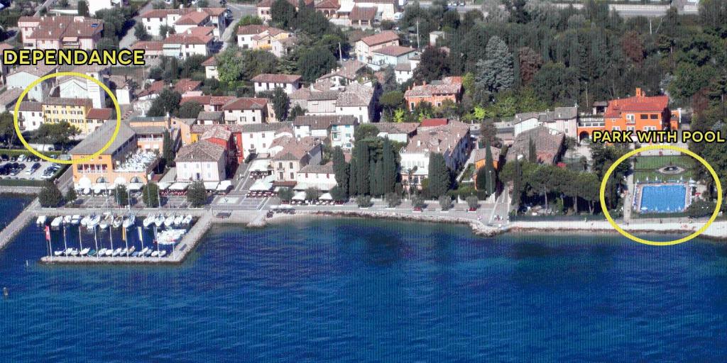 arial view of a town with a lake and buildings at Hotel Vela d'Oro Dependence in Bardolino