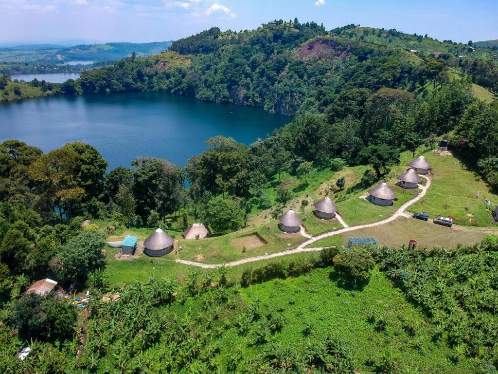 an aerial view of a village with a lake at Lake Nyamirima cottages in Fort Portal