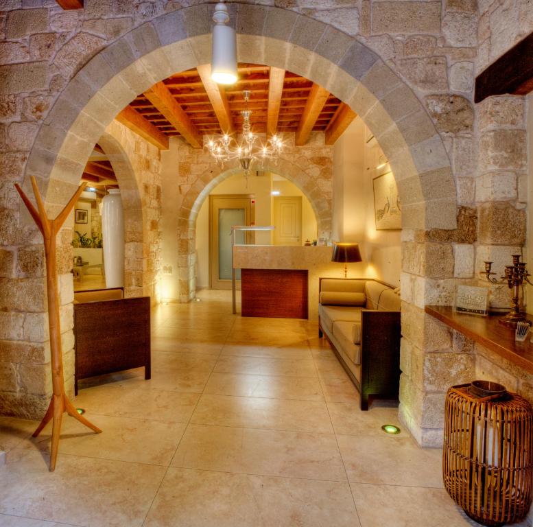 a living room with an archway in a stone building at Palazzo Duca in Chania