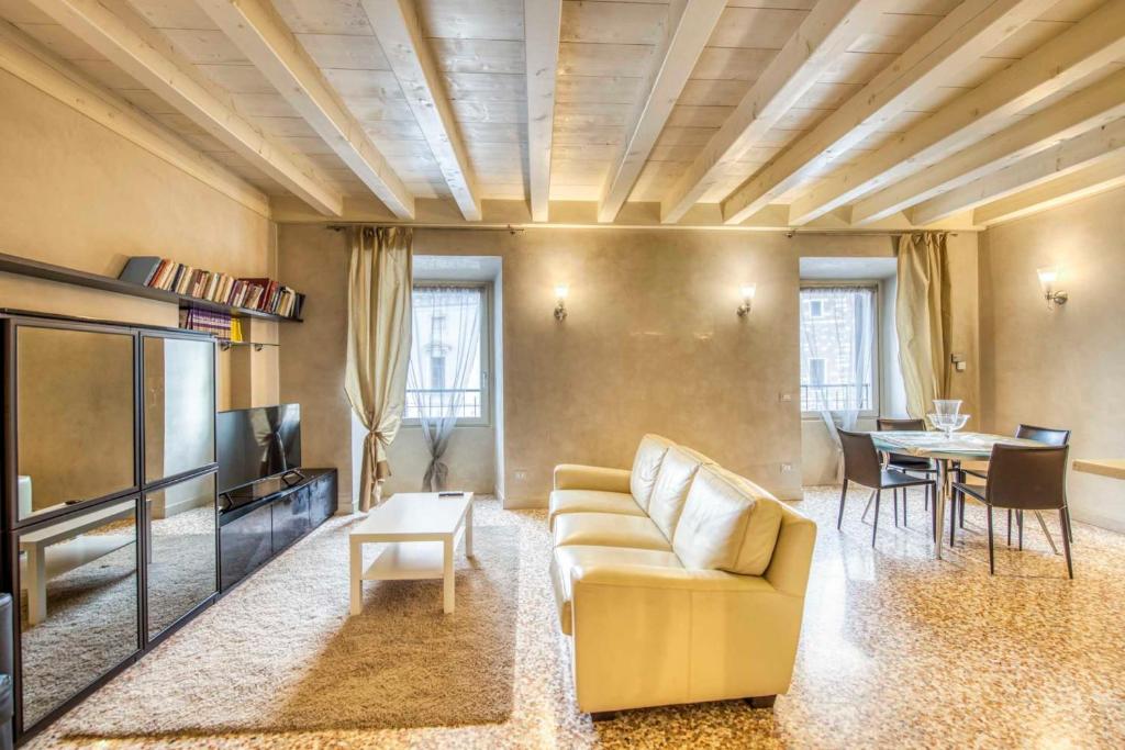 sala de estar con sofá y mesa en ApartmentsArena - Suite Mercatorum - Piazza Erbe, en Verona