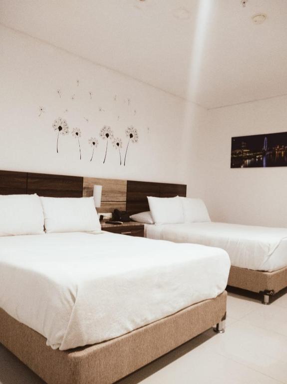 Postel nebo postele na pokoji v ubytování Hotel Oxford Barranquilla
