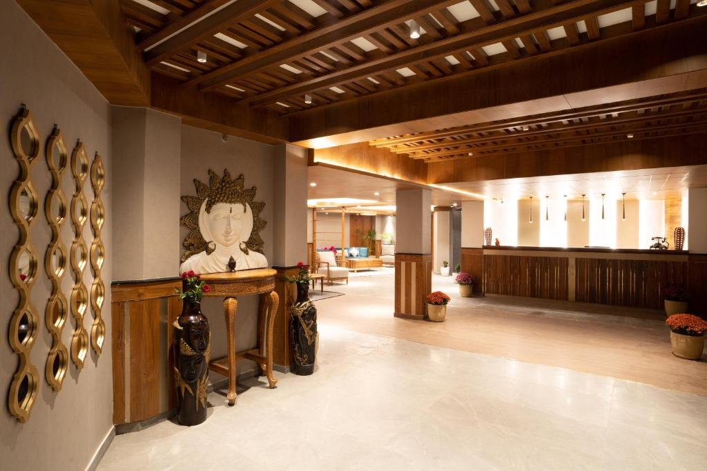 a lobby of a building with a statue of a woman at Snow Valley Heights in Shimla