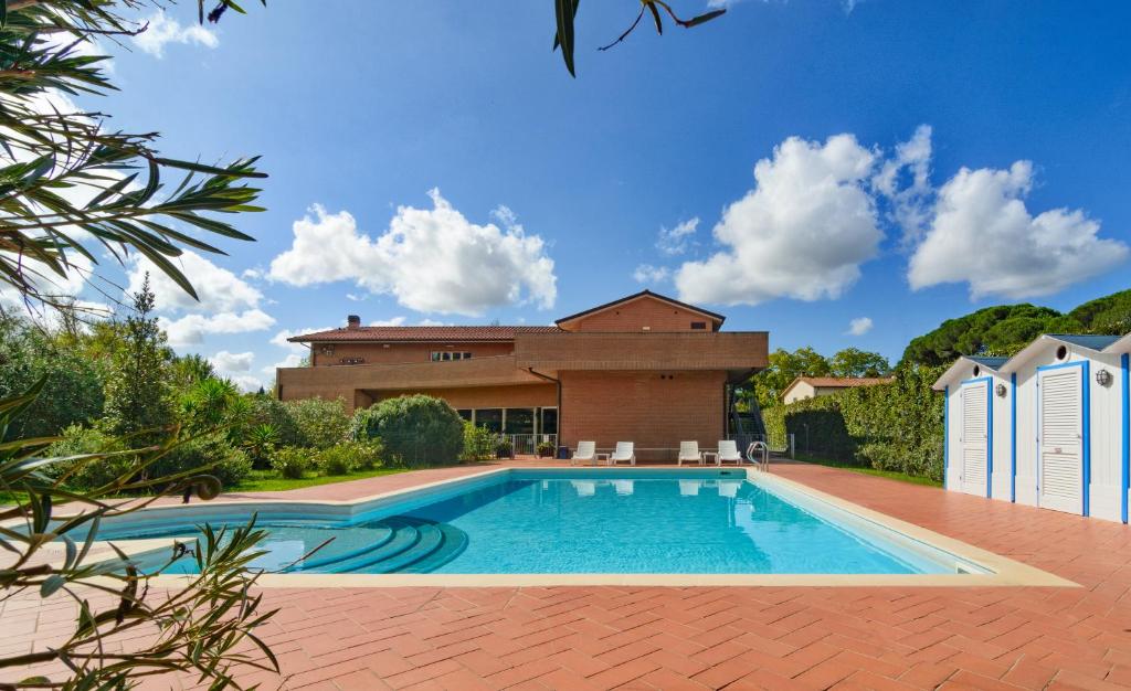 a swimming pool in front of a house at Residence San Rossore in Pisa