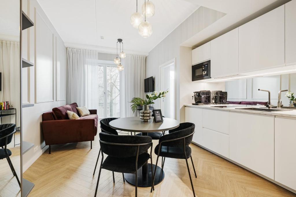 a kitchen and living room with a table and chairs at Bob W Tallinn City Centre - Ambassador in Tallinn