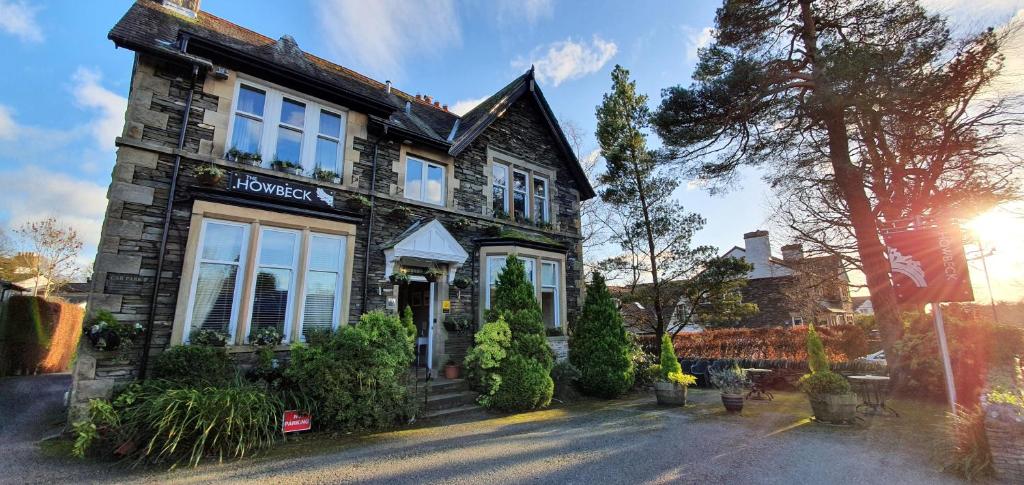 a house with a building with a sign on it at The Howbeck & The Retreat incl off-site Health Club and parking EV POINT AVAILABLE in Windermere