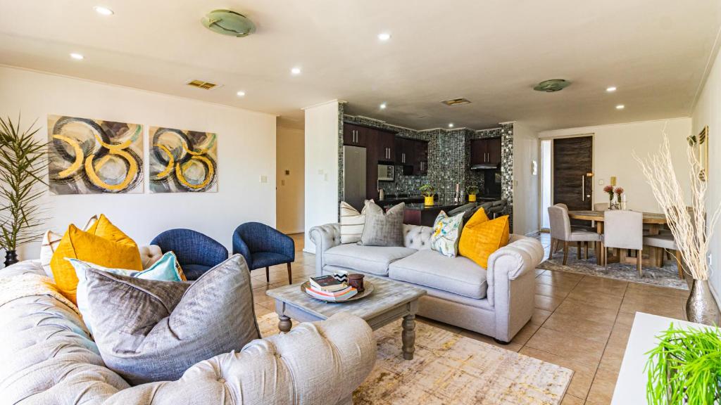 uma sala de estar com dois sofás e uma mesa em COZY LUXURY 3 BRM 4 BED em Durban