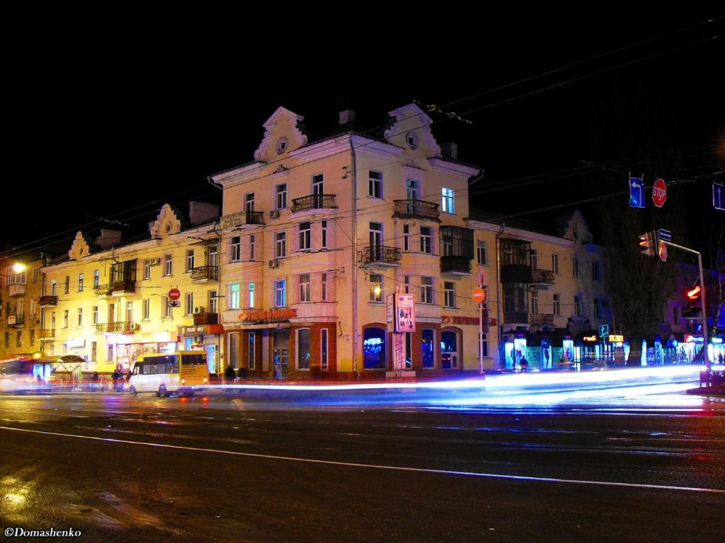 a large building on a city street at night at Apart-Hotel Parasolka in Chernihiv