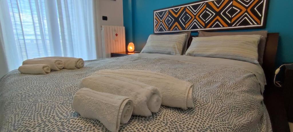 a bedroom with a large bed with towels on it at Sweet house in Bari