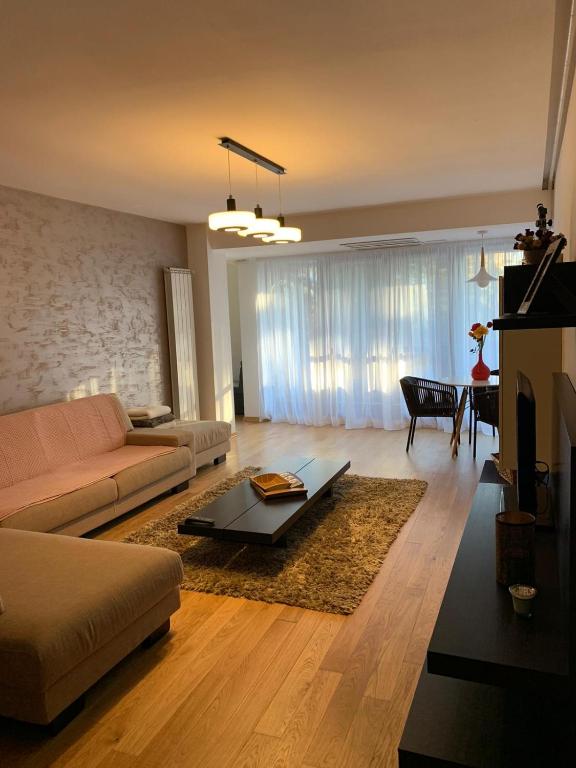 a living room with a couch and a table at Cioplea View in Predeal