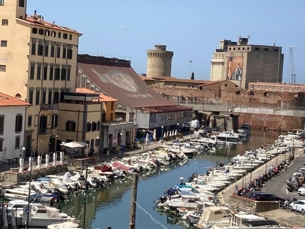 a group of boats parked in a marina with buildings at Affittacamere Ponte di Marmo in Livorno