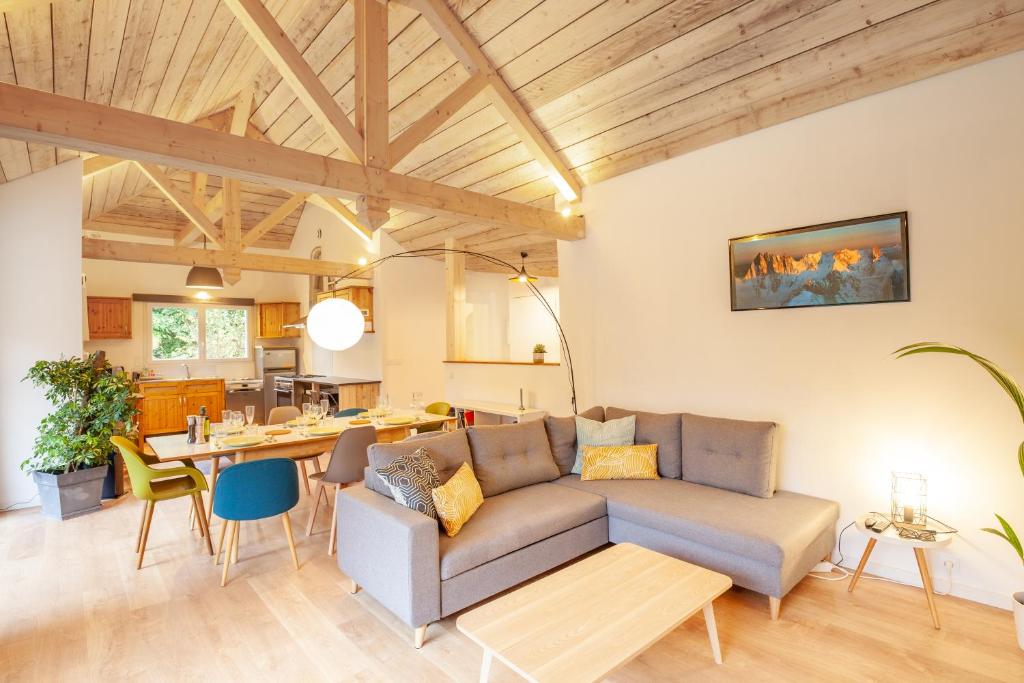 a living room with a couch and a table at La Maisonnette-Aix in Aix-les-Bains